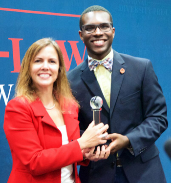 Brigida Benitez receives award from  pre-law student Justin Perkins.